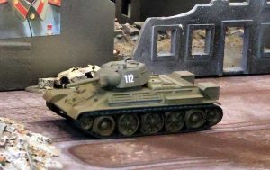 T-34 Model 1040 advancing through city ruins.